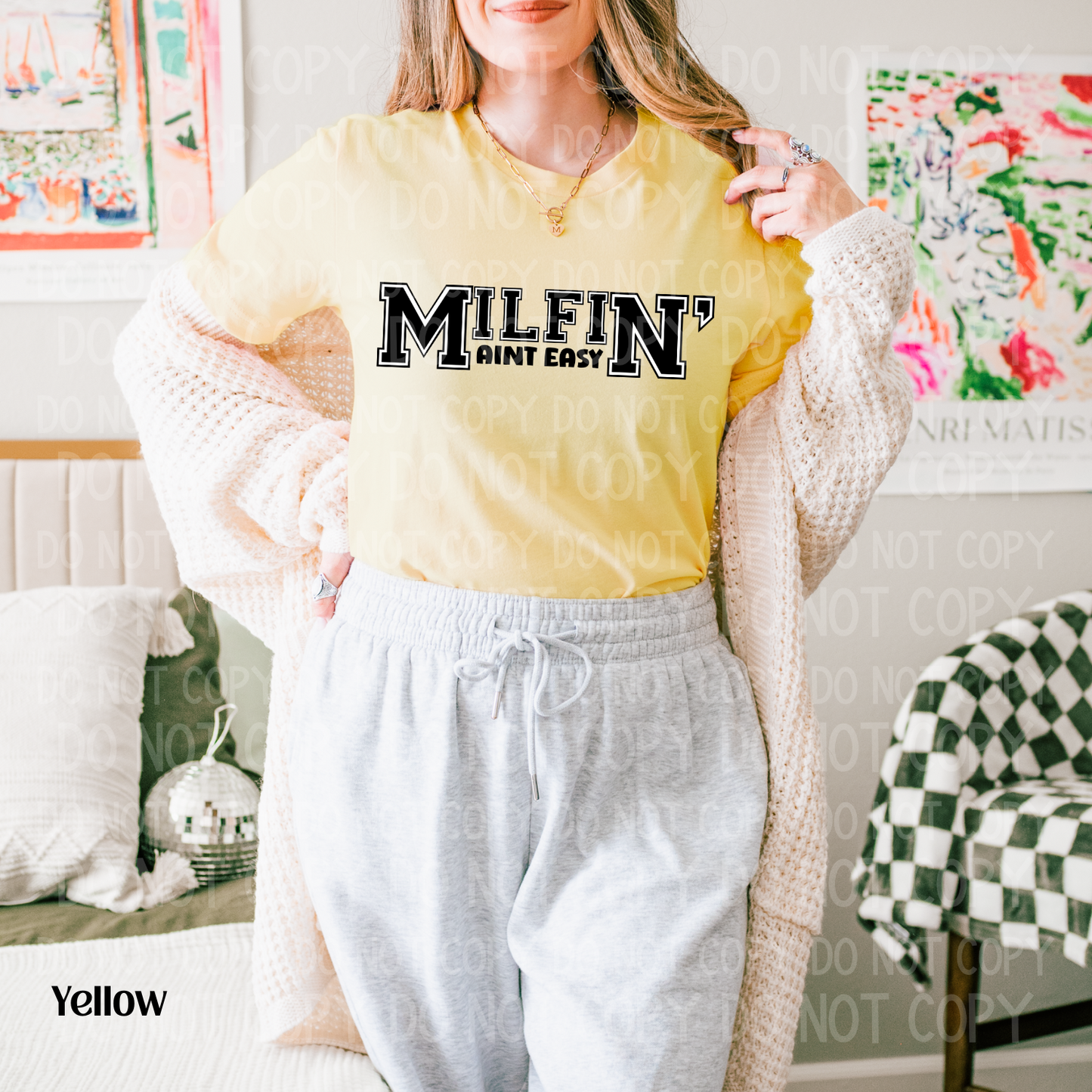 Person wearing a yellow shirt with 'MILFIN' text in a casual setting
