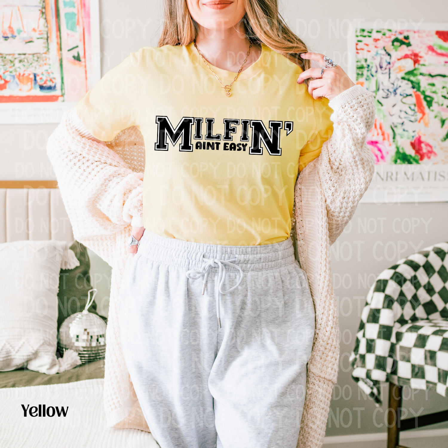 Person wearing a yellow shirt with 'MILFIN' text in a casual setting