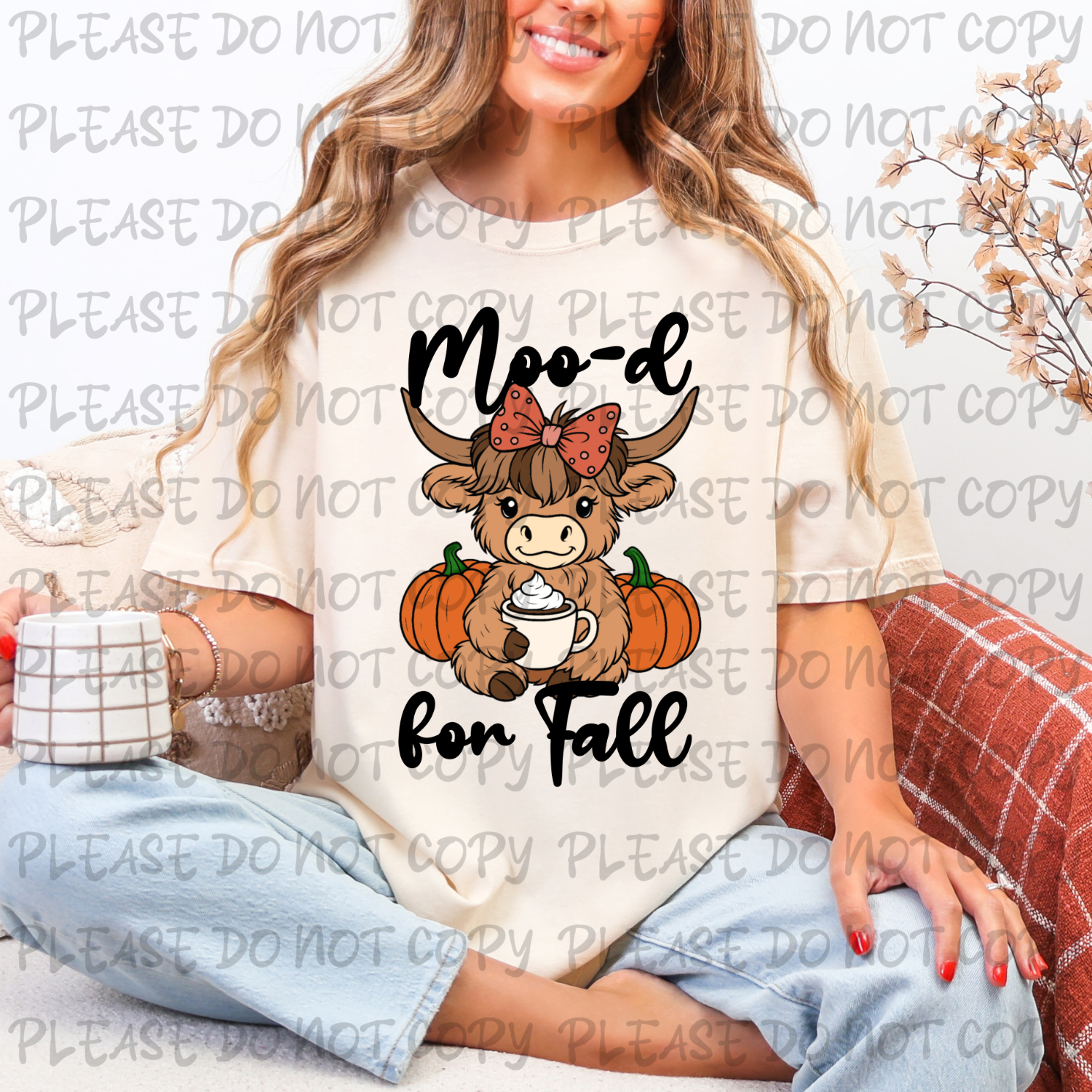 Woman wearing a shirt with a cow graphic and 'Moo-d for Fall' text, sitting on a couch.