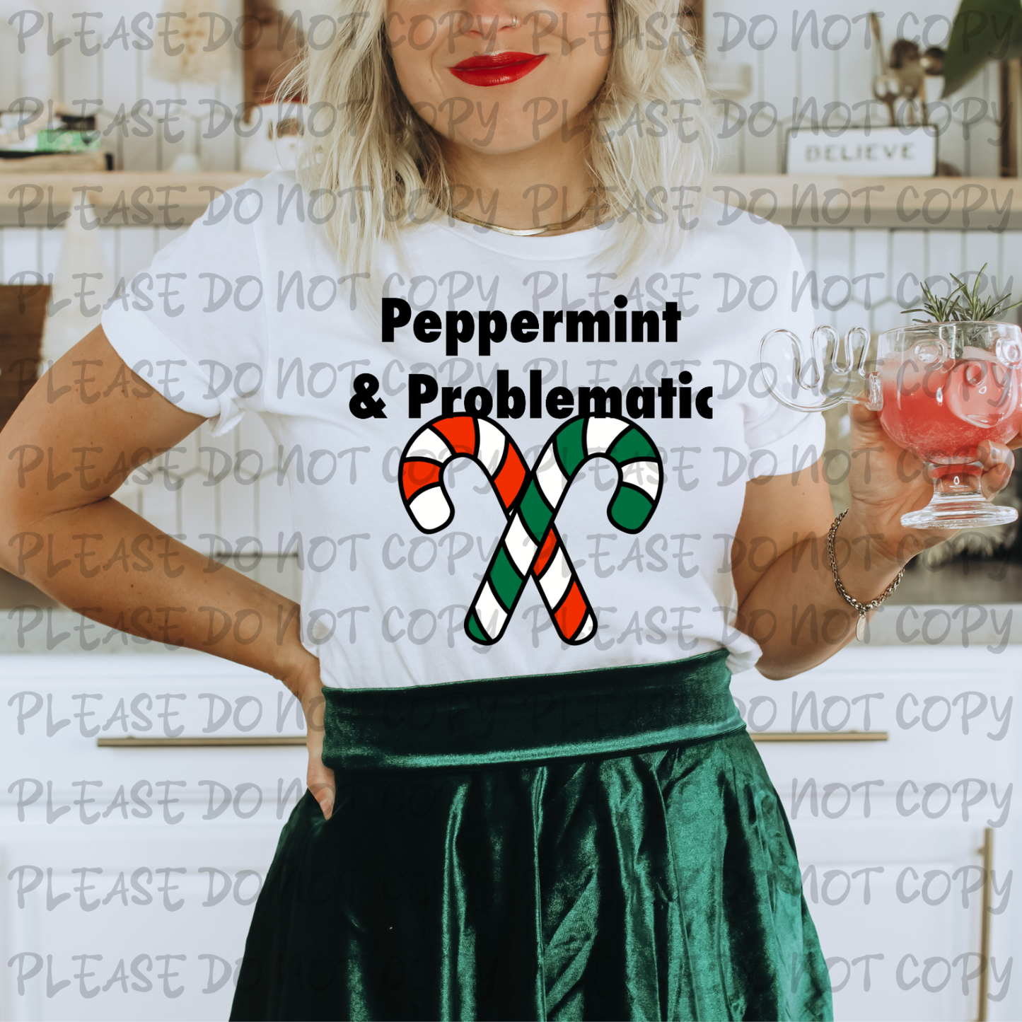 Person wearing a white t-shirt with 'Peppermint & Problematic' design, holding a drink.