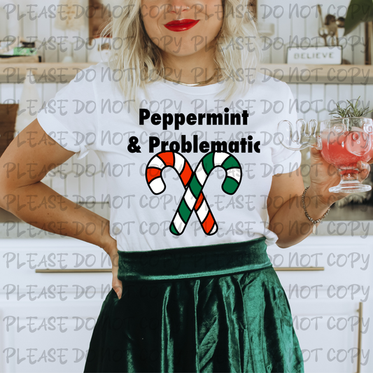 Person wearing a white t-shirt with 'Peppermint & Problematic' design, holding a drink.